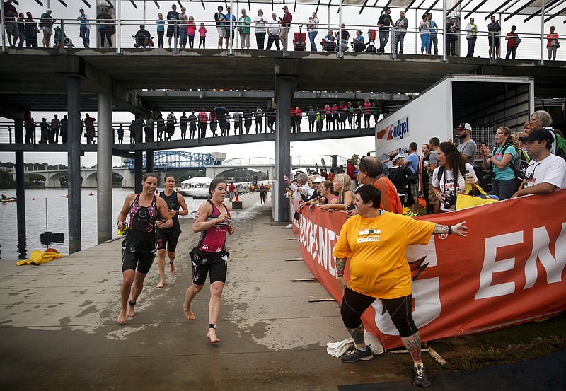 Volunteers direct athletes up a ramp at Ross's Landing for the transition from swim to bike during the Ironman Triathlon on Sunday, Sept. 27, 2015, in Chattanooga, Tenn. This marks the second year the triathlon has been held in Chattanooga.
