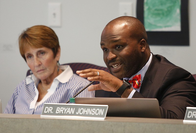 Board member Kathy Lennon, left, listens to schools superintendent Bryan Johnson discuss a state partnership zone for low performing schools during a meeting of the Hamilton County Board of Education on Thursday, Sept. 21, 2017, in Chattanooga, Tenn.