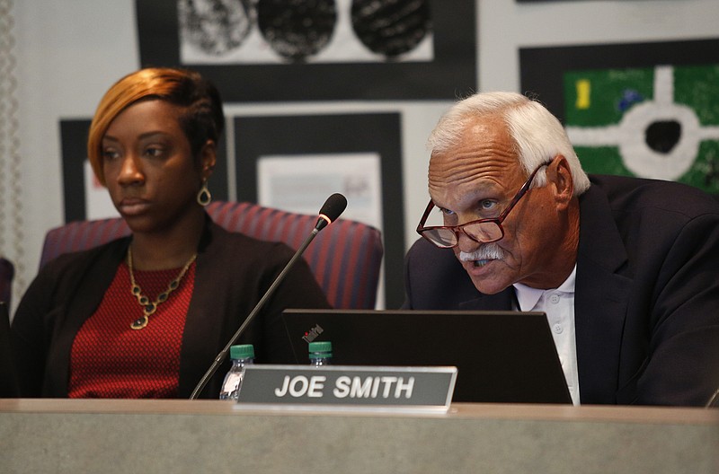 Board member Karitsa Jones, left, listens as board member Joe Smith, right, talks about a state partnership zone for low performing schools during a meeting of the Hamilton County Board of Education on Thursday, Sept. 21, 2017, in Chattanooga, Tenn.