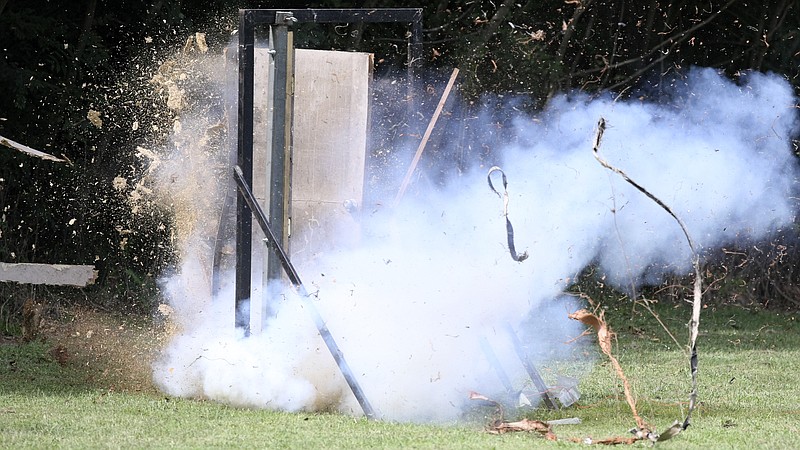 Debris flies as members of the Hamilton County Sheriff's Office SWAT team blow up a door to demonstrate a breach during a media day offering hands-on experiences and demonstrations to what they do at the law enforcement firing range on Thursday, Sept. 21, in Chattanooga, Tenn.