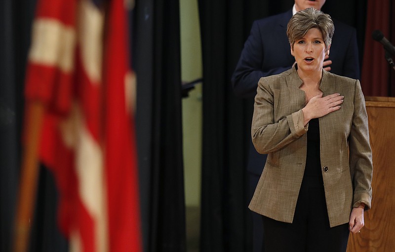 
              U.S. Sen. Joni Ernst, R-Iowa, covers her heart during the Pledge of Allegiance before a town hall meeting, Thursday, Sept. 21, 2017, in Charles City, Iowa. (AP Photo/Charlie Neibergall)
            