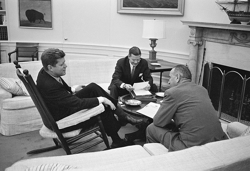 
              FILE - In this March 16, 1961 file photo, President John F. Kennedy sits in his favorite rocking chair in his office during a meeting with Secretary of Defense Robert McNamara and Vice President Lyndon B. Johnson, right, at the White House in Washington. A replica of the rocking chair commissioned and gifted by Kennedy is up for sale at a Los Angeles auction that will take place on Nov. 17, 2017. (AP Photo/Henry Burroughs, File)
            