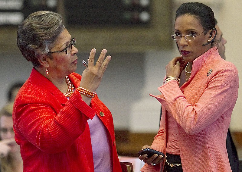 
              FILE - In this Thursday, May 26, 2011 file photo, Rep. Dawnna Dukes, right, listens to Rep Senfronia Thompson on the House floor during session in Austin, Texas. Travis County prosecutors say in a court filing that state Rep. Dukes spent more than $51,000 on an online psychic, appeared for work at the Capitol impaired and hid a cellphone from investigators. (Ralph Barrera/ Austin American-Statesman via AP)/Austin American-Statesman via AP, File)
            