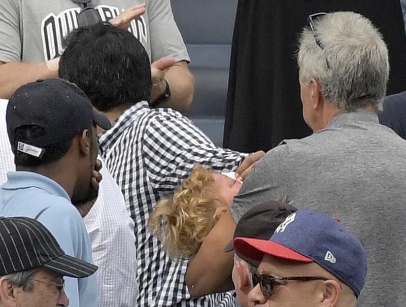 
              In this Sept. 20, 2017 photo, a young girl is carried out of the seating area after being hit by a line drive during the fifth inning of a baseball game between the New York Yankees and Minnesota Twins, at Yankee Stadium in New York. About a third of the 30 major league teams, the Yankees not among them, have extended the netting to protect fans from balls entering the bleachers to at least the end of the dugout. (AP Photo/Bill Kostroun, File)
            