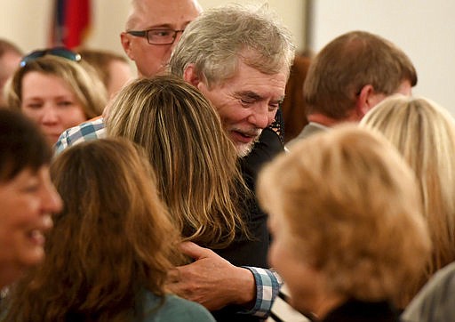 Dana and Karen Bobo hug each other after a jury on Friday found Zachary Adams guilty of murdering their daughter, Holly Bobo, in Savannah, Tenn. 