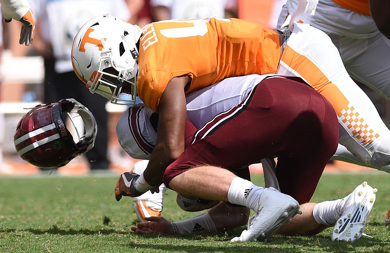 Tennessee's Elliott Berry (41) knocks UMass quarterback Andrew Ford's (7) helmet off during a tackle.  Ford did not return to the game.  The University of Massachusetts Minutemen visited the University of Tennessee Volunteers in NCAA football action in Knoxville on September 23, 2017. 