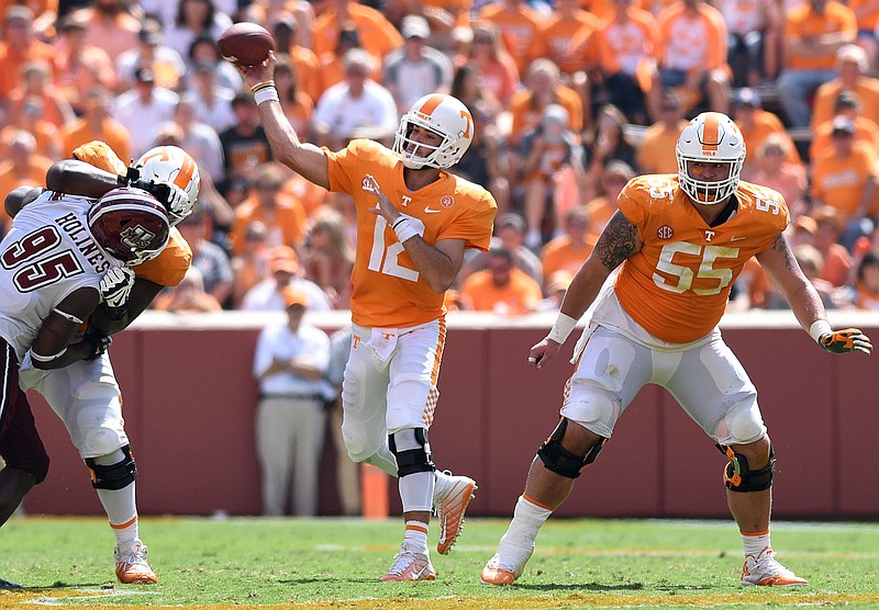 Quinten Dormady (12) throws behind the protection of Trey Smith (73) and Coleman Thomas (55).  The University of Massachusetts Minutemen visited the University of Tennessee Volunteers in NCAA football action in Knoxville on September 23, 2017. 