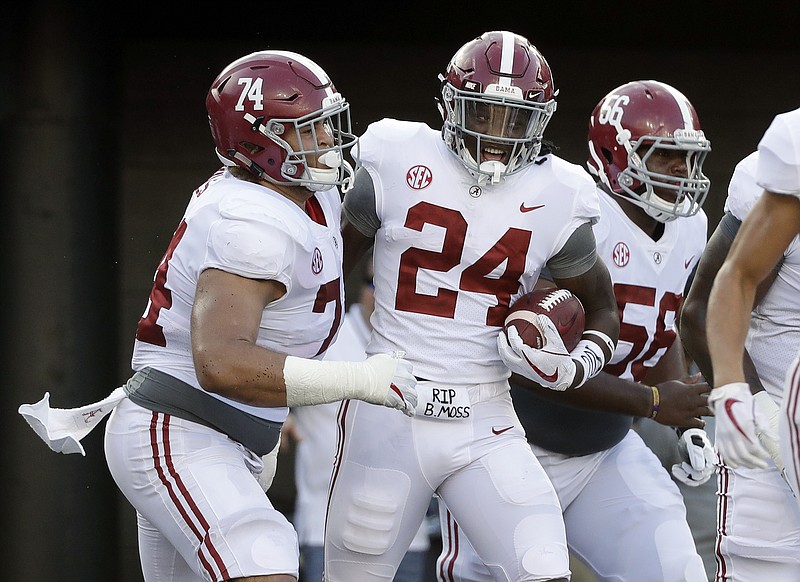 Alabama running back Brian Robinson Jr. (24) celebrates with Jedrick Wills Jr. (74) and Brandon Kennedy (56) after Robinson scored a touchdown on a 17-yard run against Vanderbilt in the second half of an NCAA college football game Saturday, Sept. 23, 2017, in Nashville, Tenn. Alabama won 59-0. (AP Photo/Mark Humphrey)