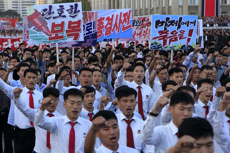 
              DELETES NUMBER OF PEOPLE - North Koreans gather at Kim Il Sung Square to attend a mass rally against America on Saturday, Sept. 23, 2017, in Pyongyang, North Korea, a day after the country's leader issued a rare statement attacking Donald Trump. The sign on the left reads "decisive revenge" and the sign on the right reads "death to the American imperialists." (AP Photo/Jon Chol Jin)
            