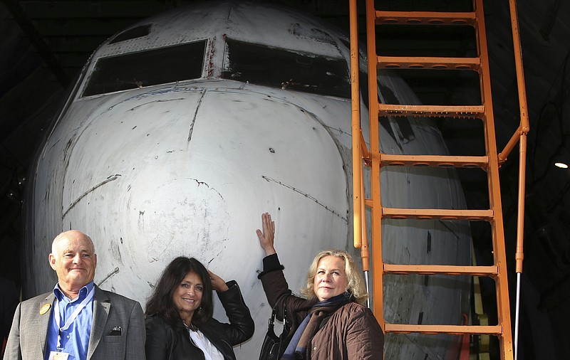 
              From left: former co-pilot Juergen Vietor, former passenger Diana Muell, and former stewardess Gabriele von Lutzau stand in front of  a part of Lufthansa plane 'Landshut' at the airport in Friedrichshafen, Germany, Saturday, Sept. 23, 2017. The  Lufthansa passenger jet hijacked to Somalia 40 years ago at the height of the leftist Red Army Faction's campaign against West German authorities has returned home. The dpa news agency reported Saturday most parts of the Boeing 737 arrived Saturday in the southern city of Friedrichshafen, where they will be reassembled and displayed at the Dornier Museum.  (Karl-Josef Hildenbrand/dpa via AP)
            