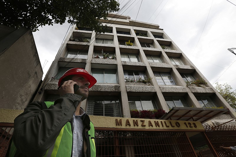 
              Architect Gabriel Martinez stands outside an earthquake damaged building, in Mexico City, Friday, Sept. 22, 2017. In quake-stricken Mexico City, hundreds of architects and engineers are volunteering to help assess the damage to thousands of buildings that suffered cracks of varying size and seriousness in the 7.1 magnitude quake that struck on Sept. 19. (AP Photo/Marco Ugarte)
            