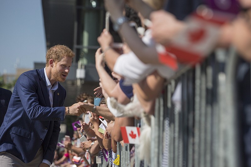 
              Prince Harry greets a waiting crowd as he visits The Centre for Addiction and Mental Health in Toronto on Saturday, Sept. 23, 2017.  (Chris Young/The Canadian Press via AP)
            