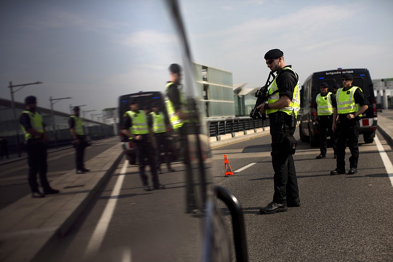 
              Police officers of Catalan Mossos d'Esquadra stand guard on a checkpoint near the airport in Barcelona, Spain Saturday, Sept. 23, 2017. Spain's Interior Ministry says that a state prosecutor has asked for the central government to coordinate the policing efforts to impede the referendum on Catalonia's secession from Spain. (AP Photo/Emilio Morenatti)
            