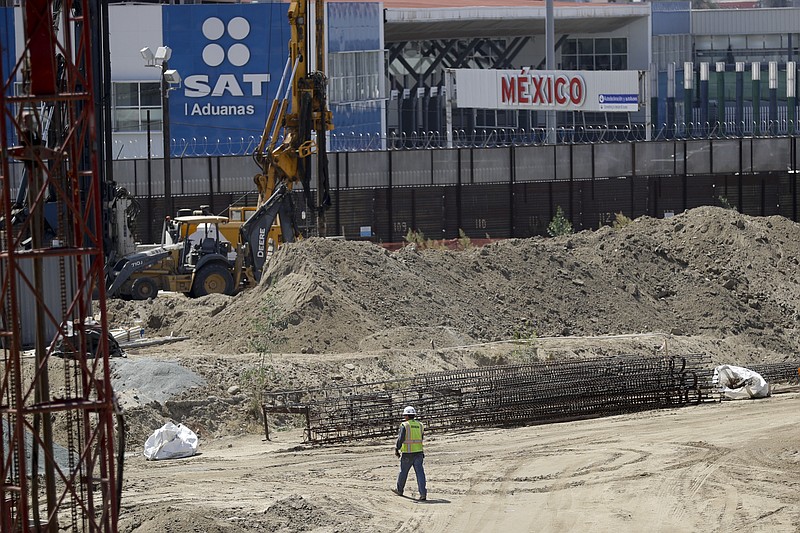 
              In this Tuesday, Sept. 19, 2017 photo, construction continues on a new curve along California's Interstate 5, as it approaches the border with Tijuana, Mexico, in San Diego. The San Diego to Tijuana border crossing, busiest border crossing in the United States will close this weekend to the more than 40,000 cars that pass through it daily to Mexico. The weekend border closure is to allow for the removal of a large metal canopy spanning over all the southbound lanes into Mexico. (AP Photo/Gregory Bull)
            