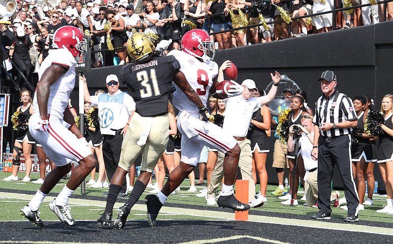 Alabama running back Bo Scarbrough gets past Vanderbilt cornerback Tre Herndon, a former East Hamilton standout, for a touchdown during Saturday's 59-0 victory over the Commodores in Nashville.