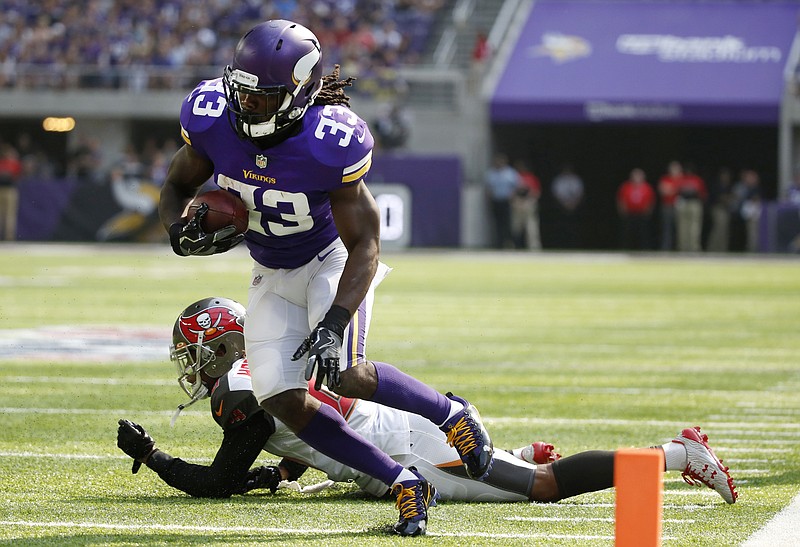 
              Minnesota Vikings running back Dalvin Cook (33) runs from Tampa Bay Buccaneers cornerback Vernon Hargreaves, rear, during the first half of an NFL football game, Sunday, Sept. 24, 2017, in Minneapolis. (AP Photo/Bruce Kluckhohn)
            