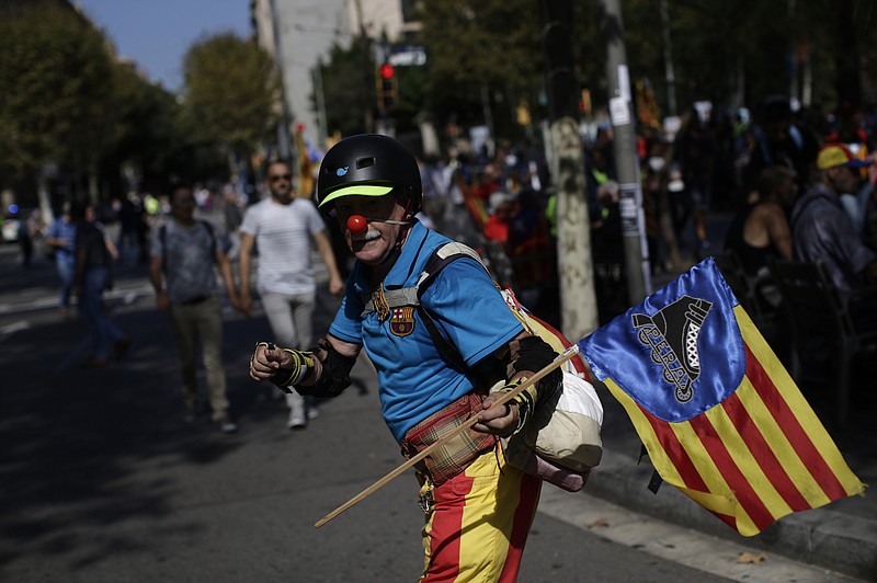 
              A man with a clown's red nose and a Catalan national flag takes part in a protest in Barcelona, Spain, Sunday, Sept. 24, 2017. Thousands of Catalan separatists are rallying in public squares in Barcelona and other towns in support of a disputed referendum on independence of the northeastern region from Spain. Many are carrying pro-independence flags and signs calling for the Oct. 1 vote that the Spanish government calls illegal and has pledged to stop. (AP Photo/Manu Fernandez)
            