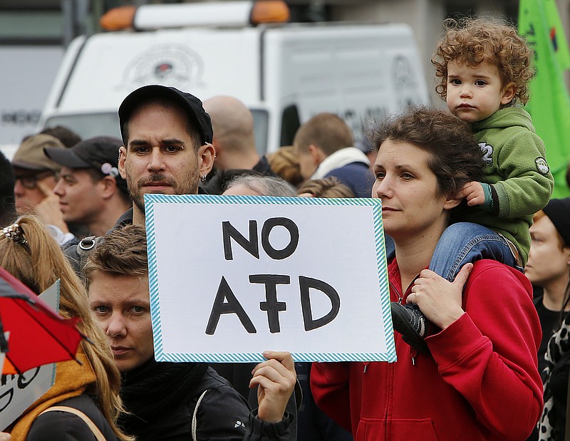 
              People take part in a demonstration of various left wing groups against German right wing party AfD (Alternative for Germany) in Berlin, Germany, Saturday, Sept. 23, 2017.(AP Photo/Michael Probst)
            