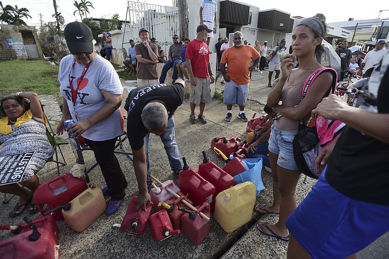 
              Hundreds of people wait in line since the morning to buy gasoline three days after the impact of Hurricane Maria in Carolina, Puerto Rico, Saturday, Sept. 23, 2017. A humanitarian crisis grew Saturday in Puerto Rico as towns were left without fresh water, fuel, power or phone service following Hurricane Maria’s devastating passage across the island. (AP Photo/Carlos Giusti)
            