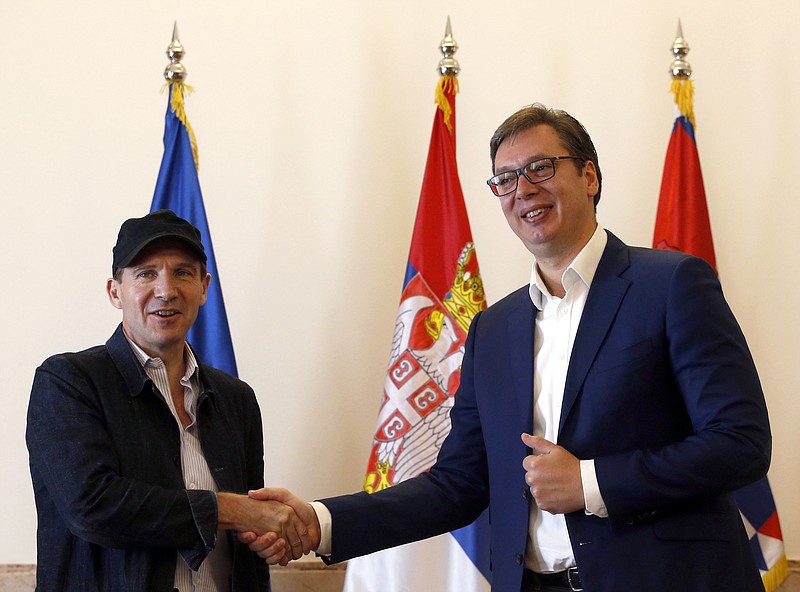 
              British actor and director Ralph Fiennes, left, shakes hands with Serbian President Aleksandar Vucic, during a meeting, in Belgrade, Serbia, Sunday, Sept. 24, 2017. Fiennes has received Serbian passport from the Balkan country's president after he was granted Balkan country's citizenship. (AP Photo/Darko Vojinovic)
            