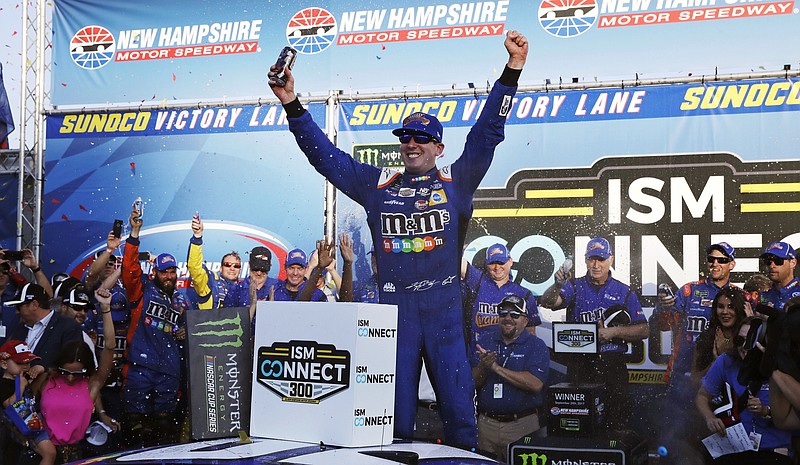 Kyle Busch raises his arms after winning the NASCAR Cup Series 300 auto race at New Hampshire Motor Speedway in Loudon, N.H., Sunday, Sept. 24, 2017. (AP Photo/Charles Krupa)