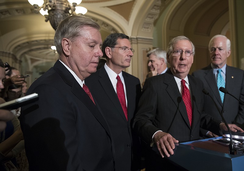 
              From left, Sen. Lindsey Graham, R-S.C., Sen. John Barrasso, R-Wyo., Sen. Bill Cassidy, R-La., Senate Majority Leader Mitch McConnell, R-Ky., and Majority Whip John Cornyn, R-Texas, speak to reporters as they faced assured defeat on the Graham-Cassidy bill, the GOP's latest attempt to repeal the Obama health care law, at the Capitol in Washington, Tuesday, Sept. 26, 2017. The decision marked the latest defeat on the issue for President Donald Trump and Senate Majority Leader Mitch McConnell in the Republican-controlled Congress. (AP Photo/J. Scott Applewhite)
            