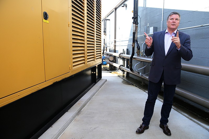 Jeff Uphues, dcBLOX Chief Executive Officer, points to generators that keep the dcBLOX data center in Chattanooga, Tenn., constantly running Friday, Sept. 22, 2017. One key to the company's success is redundancy with multiples of almost every piece that keeps the business operating if one piece fails. 