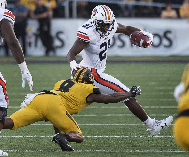 Auburn running back Kerryon Johnson, right, escapes the tackle of Missouri's Thomas Wilson, left, during the first quarter of an NCAA college football game Saturday, Sept. 23, 2017, in Columbia, Mo. (AP Photo/L.G. Patterson)