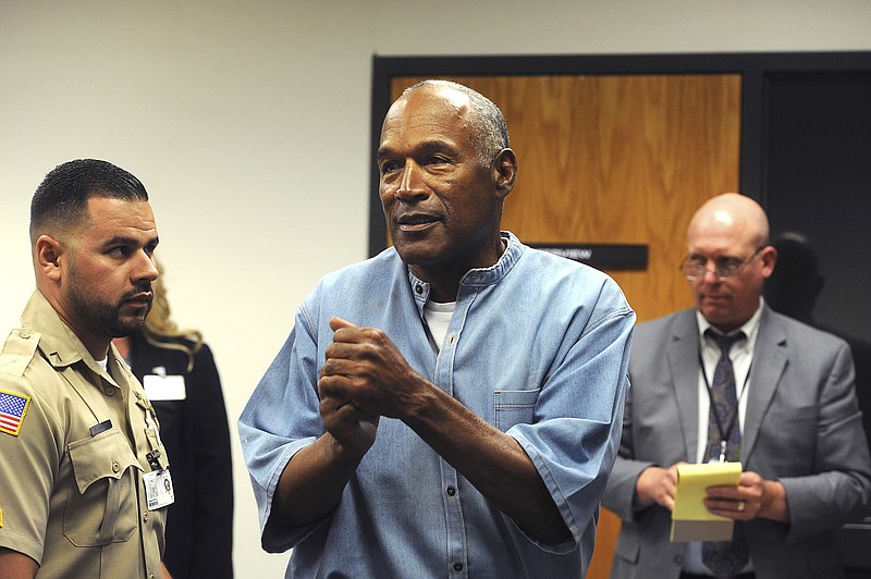 
              FILE - In this July 20, 2017 file photo, former NFL football star O.J. Simpson reacts after learning he was granted parole at Lovelock Correctional Center in Lovelock, Nev. Nevada's parole board says it didn't consider O.J. Simpson's 1989 conviction for misdemeanor spousal abuse when it granted him parole in July because it wasn't listed in the federal clearinghouse of FBI crime data.   (Jason Bean/The Reno Gazette-Journal via AP, Pool, File)
            
