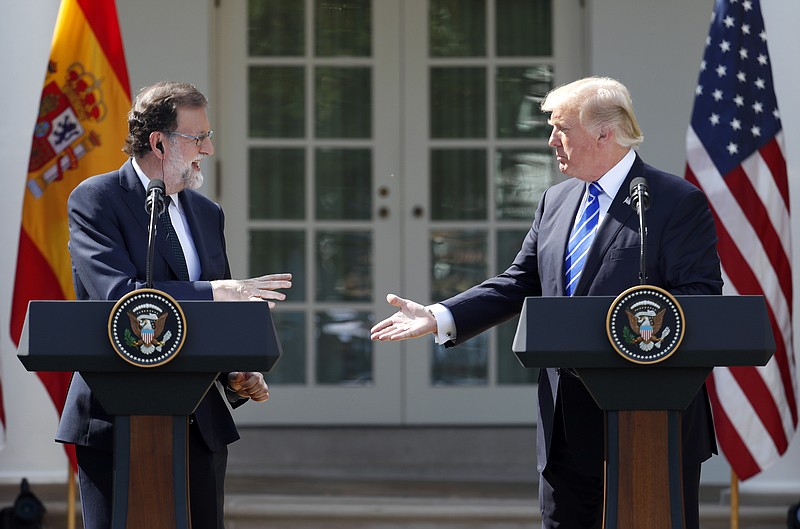 
              President Donald Trump reaches to shake hands with Spanish Prime Minister Mariano Rajoy during a news conference in the Rose Garden of the White House, Tuesday, Sept. 26, 2017, in Washington. (AP Photo/Alex Brandon)
            