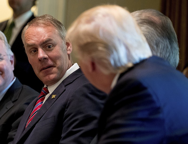 
              FILE- In this June 12, 2017, file photo, Interior Secretary Ryan Zinke, left, listens as President Donald Trump speaks during a Cabinet meeting in the Cabinet Room of the White House in Washington. Zinke said Monday, Sept. 25, that nearly one-third of employees at his department are not loyal to him and Trump, adding that he is working to change the department's regulatory culture to be more business friendly. (AP Photo/Andrew Harnik, File)
            