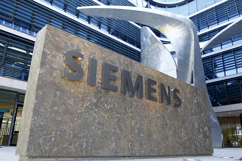
              FILE - This June 24, 2016 file photo shows the logo of German industrial conglomerate Siemens at their headquarters in Munich, Germany.  German industrial equipment maker Siemens AG said Tuesday Sept. 26, 2017, it has signed a memorandum of understanding to merge its train-building business with French rival Alstom, creating a "new European champion" in the face of growing competition from China. (AP Photo/Matthias Schrader, FILE)
            
