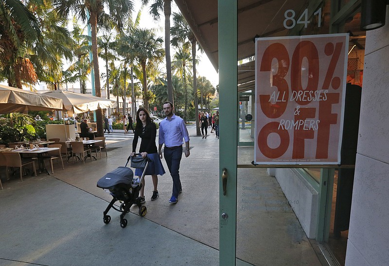 
              In this Wednesday, April 26, 2017, photo, pedestrians walk past a store on Miami Beach, Florida's Lincoln Road. American consumers feel a bit less confident in September 2017, their spirits pulled down by Hurricanes Harvey and Irma, according to consumer confidence index information released Tuesday, Sept. 26, 2017, by the Conference Board. (AP Photo/Wilfredo Lee)
            