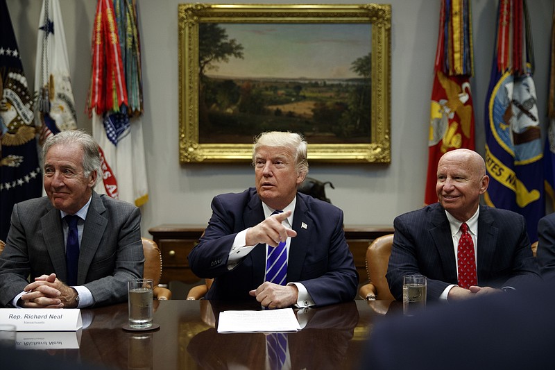 
              Rep. Richard Neal, D-Mass., left, and Rep. Kevin Brady, R-Texas, right, listen as President Donald Trump speaks during a meeting with members of the House Ways and Means committee in the Roosevelt Room of the White House, Tuesday, Sept. 26, 2017, in Washington. (AP Photo/Evan Vucci)
            