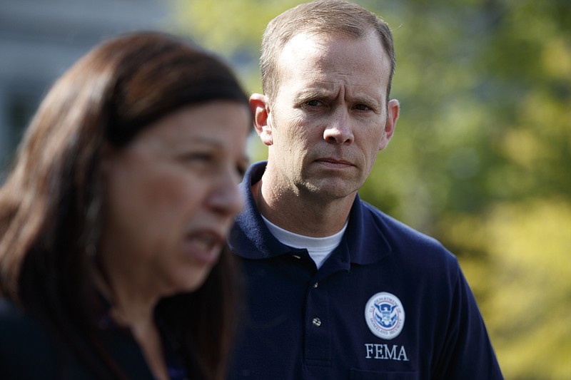 
              FEMA administrator Brock Long, right, looks on acting Secretary of Homeland Security Elaine Duke speaks to reporters about hurricane recovery efforts in Puerto Rico, outside the White House, Tuesday, Sept. 26, 2017, in Washington. (AP Photo/Evan Vucci)
            