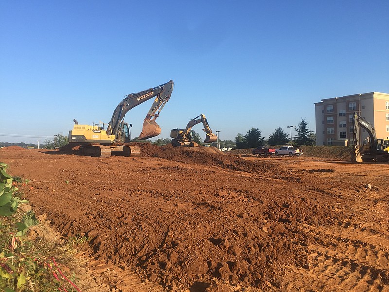 Bulldozers prepare a site on Center Street near the Shallowford Road exit on Interstate 75 for a 97-room Home2 Suites by Hilton.