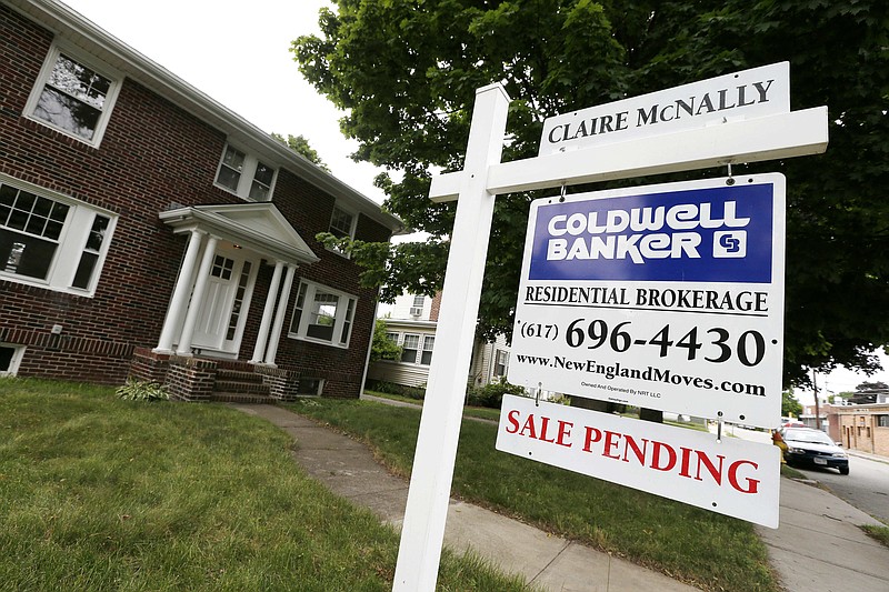 FILE - In this July 10, 2014, file photo, a "Sale Pending" sign is posted in front of a home for sale in Quincy, Mass. On Wednesday, Sept. 27, 2017, the National Association of Realtors releases its August report on pending home sales, which are seen as a barometer of future purchases. (AP Photo/Michael Dwyer, File)