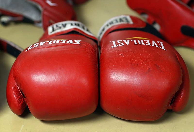 Boxing gloves lay on a table during the Brigade Boxing Championships at the U.S. Naval Academy in Annapolis, Md., Friday, Feb. 28, 2014. The academy has offered boxing since 1865, both as a club sport as well as a required part of the physical education program. (AP Photo/Patrick Semansky)