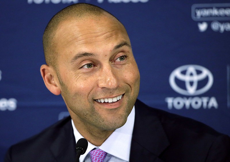 
              FILE - In this Sept. 28, 2014, file photo, New York Yankees' Derek Jeter speaks to the media after the last baseball game of his career, against the Boston Red Sox, at Fenway Park in Boston. Two people familiar with the vote say major league owners have approved the sale of the Miami Marlins by Jeffrey Loria to an investment group led by Bruce Sherman and Derek Jeter.  The people confirmed the vote to The Associated Press on condition of anonymity Wednesday, Sept. 27, 2017, because the approval had not been announced. One of the people said the vote was unanimous, with 75 percent approval needed. (AP Photo/Steven Senne, File)
            