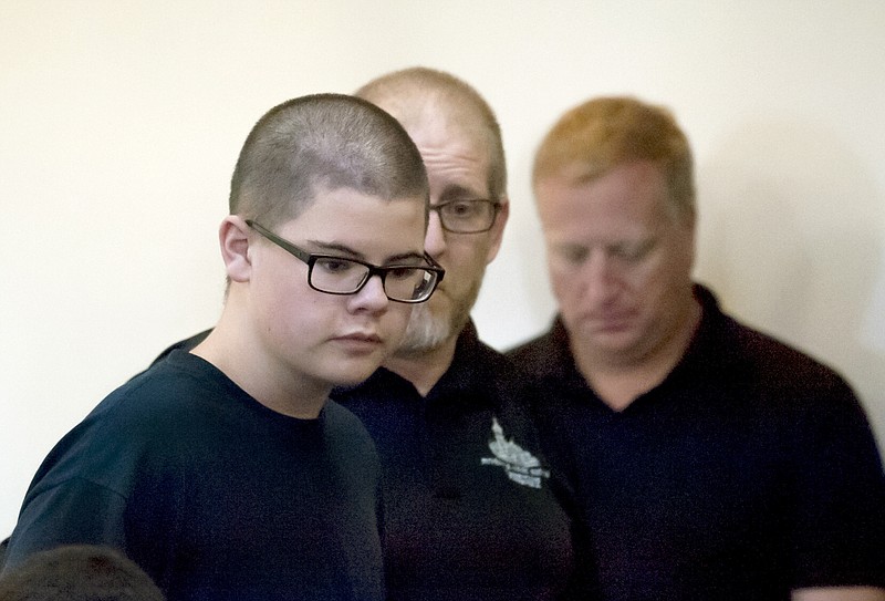 
              Caleb Sharpe walks into Spokane County Juvenile Court to a packed courtroom on Wednesday, Sept. 27, 2017, in Spokane, Wash. A hearing to determine whether the 15-year-old boy will be tried as an adult on charges he fatally shot a classmate and wounded three others at his rural Washington state high school will not occur until next spring, a judge said Wednesday.  (Kathy Plonka /The Spokesman-Review via AP)
            