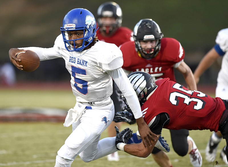 Red Bank's Calvin Jackson (5) gets past the attempted tackle of Signal Mountain's Collin Weigert (35).  The Red Bank Lions visited the Signal Mountain Eagles in TSSAA football action on Friday September 30, 2016.