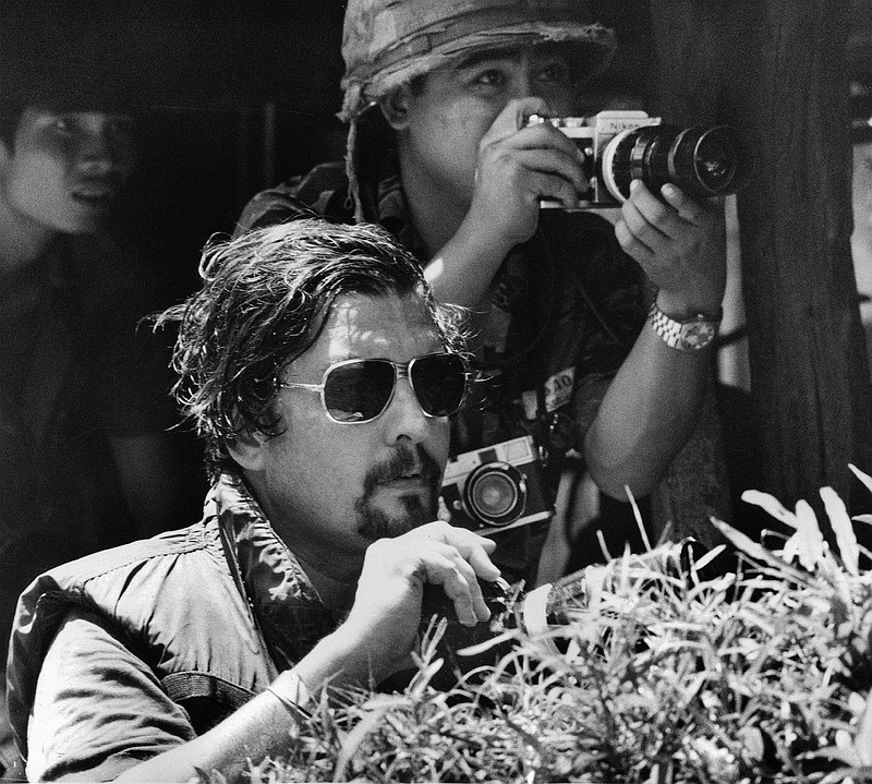 
              FILE - In this October 1972 file photo, Richard Pyle, former Saigon Chief of Bureau, foreground, and photographer Nick Ut watch the battle of Xom Suoi, Vietnam, a village on Highway 13 known as "Thunder Road," about 30 miles north of Saigon. Pyle, an Associated Press reporter whose career spanned a half-century of war, catastrophe and other indelible stories has died in New York, Thursday, Sept. 28, 2017. Richard Pyle was 83. (AP Photo/Dang Van Phuoc, File)
            