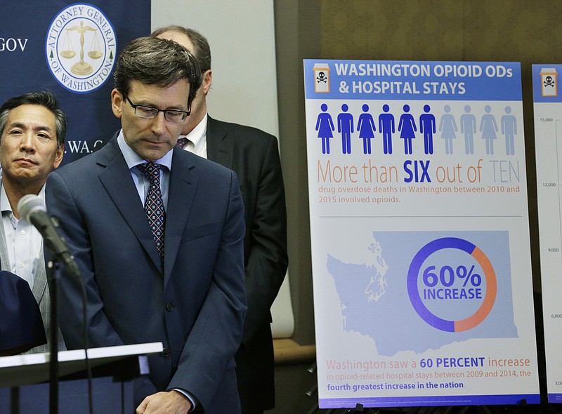 
              Washington Attorney General Bob Ferguson, second from left, listens to a question, Thursday, Sept. 28, 2017, in Seattle, as he stands near a chart detailing increases in overdoses and hospital stays relating to opioid use in Washington state. Ferguson said Thursday that the state and the city of Seattle are filing lawsuits against several makers of opioids, including Purdue Pharma, seeking to recoup costs incurred by government when the drugs -- which many officials blame for a national addiction crisis -- are abused. (AP Photo/Ted S. Warren)
            