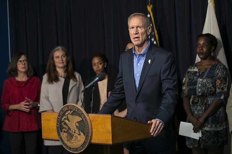 
              Flanked by supporters, Illinois Gov. Bruce Rauner announces at a news conference that he'll sign legislation allowing state health insurance and Medicaid coverage for abortions, Thursday, Sept. 28, 2017 in Chicago. The move ended months of speculation after the Republican reversed his stance on the issue last spring. (Ashlee Rezin/Chicago Sun-Times via AP)
            