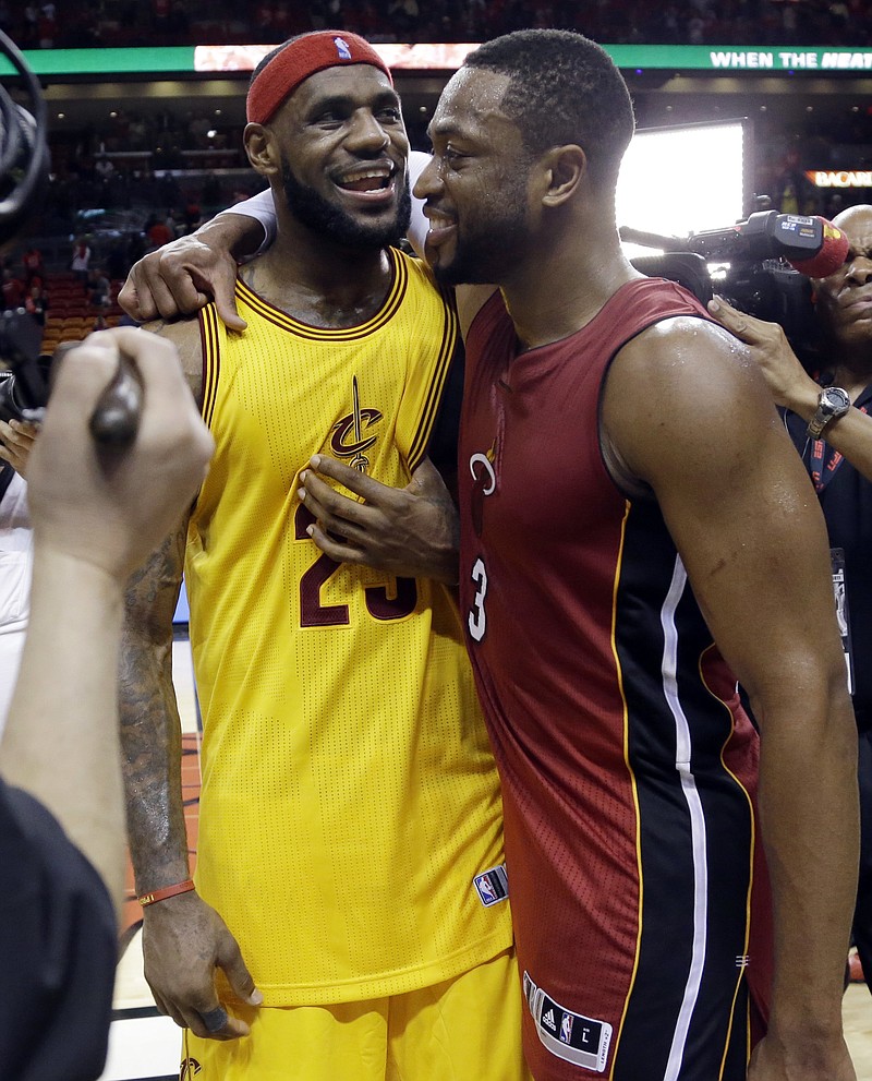 
              FILE - In this Dec. 25, 2014, file photo, Cleveland Cavaliers forward LeBron James (23) and Miami Heat guard Dwyane Wade talk following an NBA basketball game in Miami. Wade is expected to sign Wednesday, Sept. 27, 2017, with the Cavaliers, reuniting the 12-time All-Star with James, a former Miami teammate and one of his best friends.  (AP Photo/Lynne Sladky, File)
            