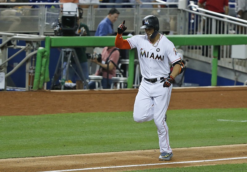 Miami Marlins' Giancarlo Stanton celebrates as heads for home plate after hitting a home run during the fourth inning of a baseball game against the Atlanta Braves, Thursday, Sept. 28, 2017, in Miami. (AP Photo/Wilfredo Lee)
