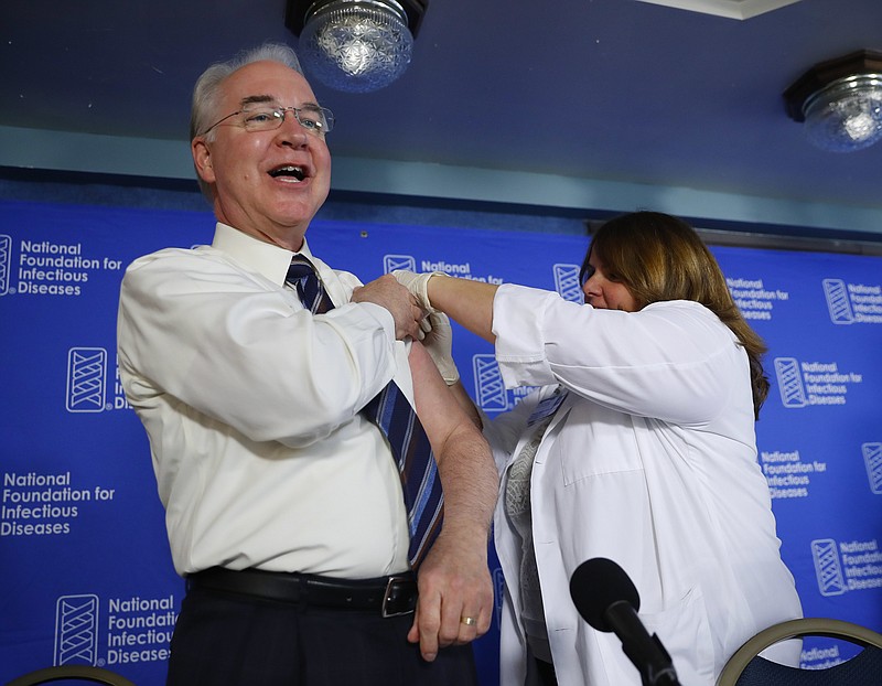 
              Health and Human Services Secretary Tom Price, left, receives a flu vaccination from Sharon Walsh-Bonadies, RN., right during a news conference recommending everyone age six months an older be vaccinated against influenza each year, Thursday, Sept. 28, 2017 in Washington. (AP Photo/Pablo Martinez Monsivais)
            