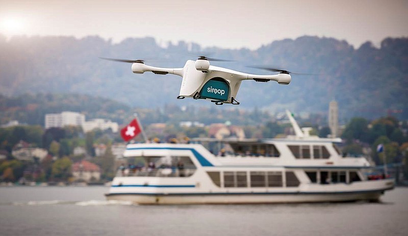 
              In this image made available from Matternet Thursday Sept. 28, 2017, a Matternet drone is pictured transporting on-demand e-commerce goods in Zurich, Switzerland.  Drones will soon start to deliver small items in Zurich as part of a pilot project, the first of its kind over a populated area, transporting goods about 8 to 16 kilometers (5 to 10 miles) to awaiting delivery vans and the van drivers will then deliver them to customers. (Matternet via AP)
            
