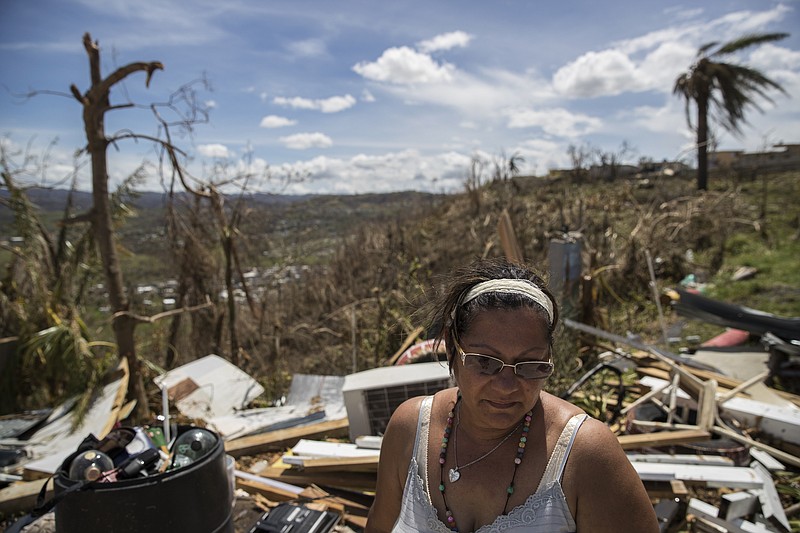 Lucy Cedeno, 53, stands on the remains of her home that was destroyed in Hurricane Maria, in the hill town of Toa Alta, Puerto Rico. (Victor J. Blue/The New York Times)