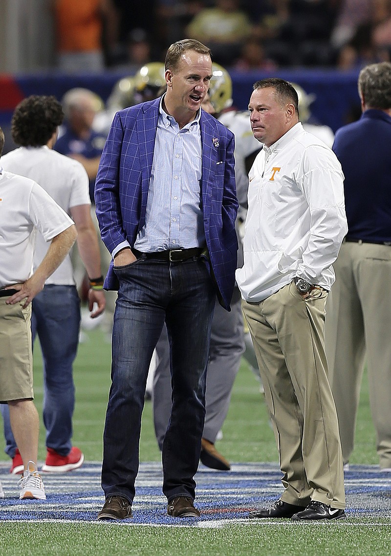 Former Tennessee quarterback Peyton Manning stands with Vols coach Butch Jones before the season opener against Georgia Tech at Atlanta's Mercedes-Benz Stadium.